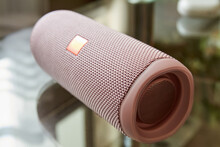 A Part Of Portable Pink Bluetooth And Wireless Speaker On A Glass Surface. Close-up, Selective Focus