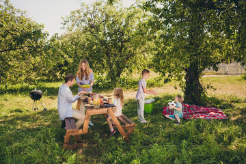 Poster - Portrait of nice attractive adorable careful affectionate idyllic cheery full big family small little brother sister enjoying bbq in fresh air spending free spare time weekend rest relax pastime