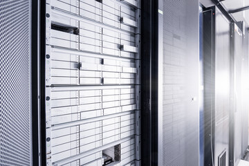 cabinet with sas hard drives in data center with light rays