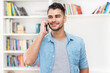 © Daniel Ernst - Laughing hispanic hipster man in quarantine talking at mobile phone