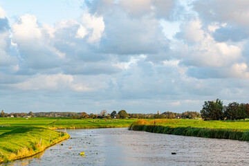 Wall Mural - View during sunrise on the meadows and the canal along the Geerpolder near lake Zoetermeerse Plas