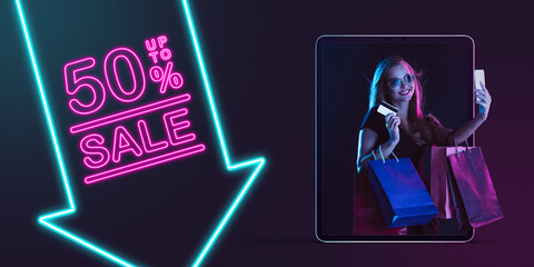 Beautiful woman inviting for shopping right from device screen, black friday, sales concept. Flyer. Cyber monday and online purchases, negative space for ad. Finance and money. Dark neon background.