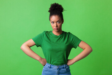 Portrait of angry black woman standing at studio