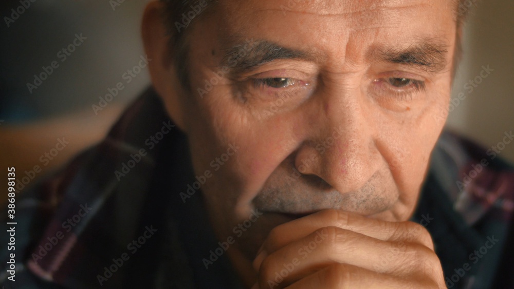 Sad senior man thinking, looking down. Closeup, shallow DOF. - obrazy, fototapety, plakaty 