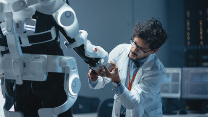 Poster - In Robotics Development Laboratory: Top Male Scientist Works on a Bionics Exoskeleton Prototype. Team of Engineers Designing Powered Exosuit to Help Disabled People Walk, Labor Workers to Lift Goods