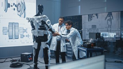 Wall Mural - In Robotics Development Laboratory International Team of Engineers and Scientists Work on Robotics Exoskeleton Prototype. Designing Powered Exosuit to Help Disabled People Walk, Workers to Lift Goods