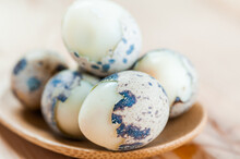 Boiled Quail Eggs On A Wooden Spoon Close-up.