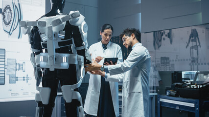 Poster - In Robotics Development Laboratory: Chief Female Engineer and Top Male Scientist Work on a Bionics Exoskeleton Prototype. Designing Powered Exosuit to Help Disabled People, Hard Labor Workers