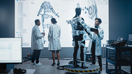 Wall Mural - In Robotics Development Laboratory: Female Engineer and Male Scientist Work With Big Screen Showing Robotics Exoskeleton Prototype Design. Building Exosuit to Help Disabled People, Hard Labor Workers
