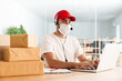 © Drobot Dean - Male delivery assistance in face mask working with packages and laptop