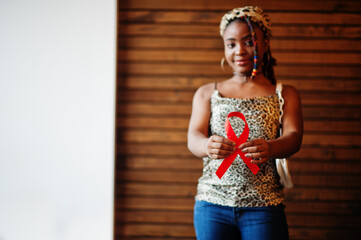 aids awareness. stylish african american woman hold red ribbon.