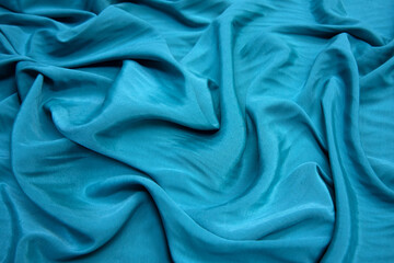 Wall Mural - Turquoise plain silk fabric as background close up