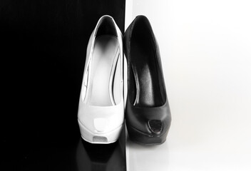 Sticker - white and black high-heeled shoes on an abstract white and black background