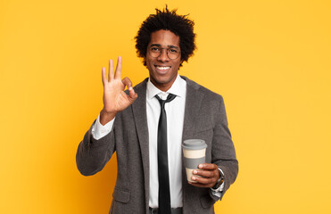 Wall Mural - young black afro man feeling happy, relaxed and satisfied, showing approval with okay gesture, smiling