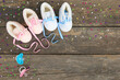 © Viktoriia M - 2021 new year written laces of children's shoes and pacifier on old wooden background. Top view. Flat lay.