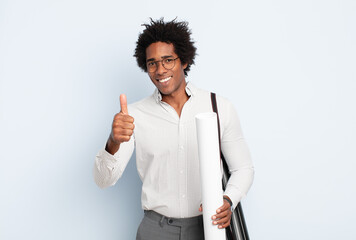 Wall Mural - young black afro man feeling proud, carefree, confident and happy, smiling positively with thumbs up