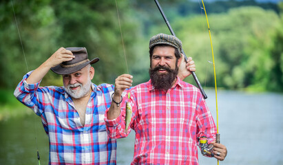 Wall Mural - Family is Best. hobby and sport activity. Trout bait. summer weekend. mature men fisher. father and son fishing. two happy fisherman with fishing rods. male friendship. family bonding