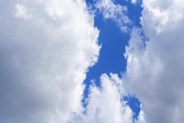 white cumulus clouds against a bright blue sky