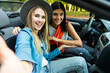 © F8  \ Suport Ukraine - Couple of best friends women taking a selfie at car trip. Two young girl having fun togheter smiling at the camera.