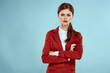 Elegant woman in red jacket bright makeup lips self-confidence cropped view blue background