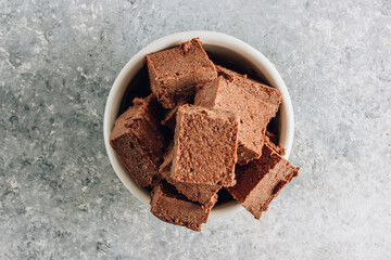 Raw vegan chocolate fudge. Healthy vegan food concept.