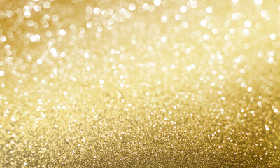 Golden sparkle glitters with bokeh effect and selectieve focus. Festive background with bright gold lights, champagne bubble. Christmas mood concept. Copy space, close up, texture, top view.