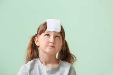 Sticker - Little girl with blank note paper on her forehead against color background