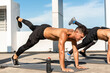 © Atstock Productions - Fit sports men doing plank leg raise exercise in the open air on building rooftop