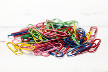 Colorful Paperclips On Old White Table