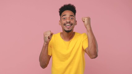 Sticker - Excited happy young african american man 20s years old in yellow t-shirt posing isolated on pastel pink background in studio. People lifestyle concept. Doing winner gesture covering mouth with hand