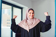 Strong independent Muslim woman showing her power while wearing abaya. Female empowerment concept