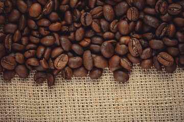 Roasted coffee beans on burlap. Background for coffee shops and store websites