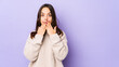© Asier - Young mixed race hispanic woman isolated shocked, covering mouth with hands, anxious to discover something new.