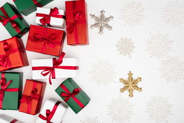 Canvas Print - top view of colorful gift boxes and decorative snowflakes on white background