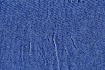 Poster - The texture of the rough fabric is bright blue. Uneven, wrinkled fabric. Simple, plain blue cotton fabric background.