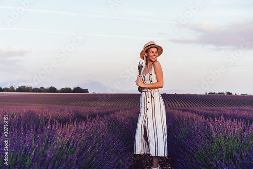 Smiling female explorer discovering lavender fields