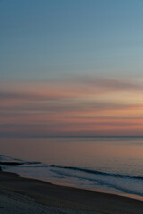 Wall Mural - beautiful sunset over the ocean with colorful sky and small waves