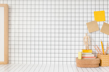 Wall Mural - Table with wooden school supplies, notes, books, boxes and checkered background.