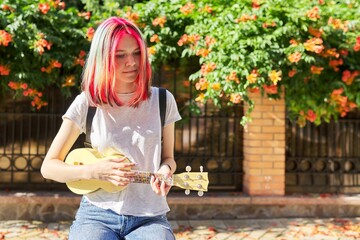 Sticker - Hipster teenager playing ukulele sitting outdoors