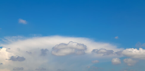 Wall Mural - Blue sky background with fluffy clouds