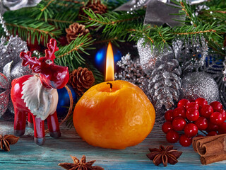 Background of the New year.Candles burn on glass candlesticks, against the background of pine branches and Christmas decorations.