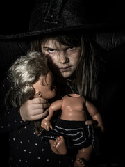 Creepy young girl with scary doll