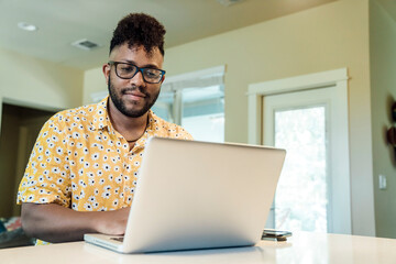 Wall Mural - Man working from home on laptop computer