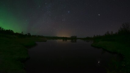 Wall Mural - aurora borealis and stars reflecting in calm water thingvellir iceland fisheye
