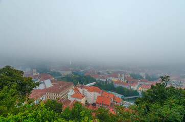 Cityscape of Graz from Schlossberg hill on a autumn foggy day, Graz, Styria region, Austria