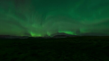 Wall Mural - aurora borealis over snow mountains and wide open tundra in iceland