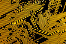 Golden Conductive Tracks On A Black Circuit Board, Abstract Background. Printed Circuit Board Detail. Microelectronics Development Concept.