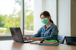 © Prasit Rodphan - Asian university student girl wearing face protective medical mask and smile for protection from virus disease working with laptop at college.
