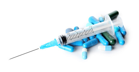 Pills and syringe for injection on white background