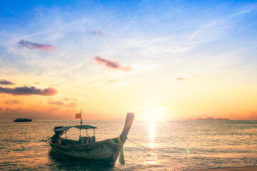 Wall Mural - Sunrise sky background concept: Traditional Thai long tail boat at beautiful sunrise background